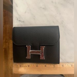 Black wallet with silver buckle. Purchased from DH Gate. Brand new, never used.